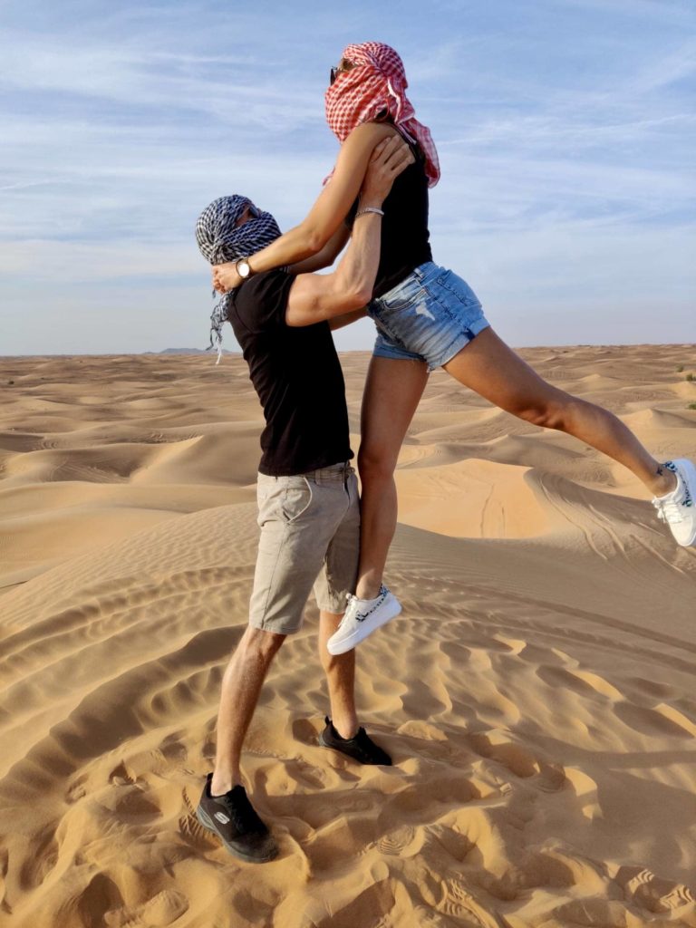 couple pose in the desert of dubai