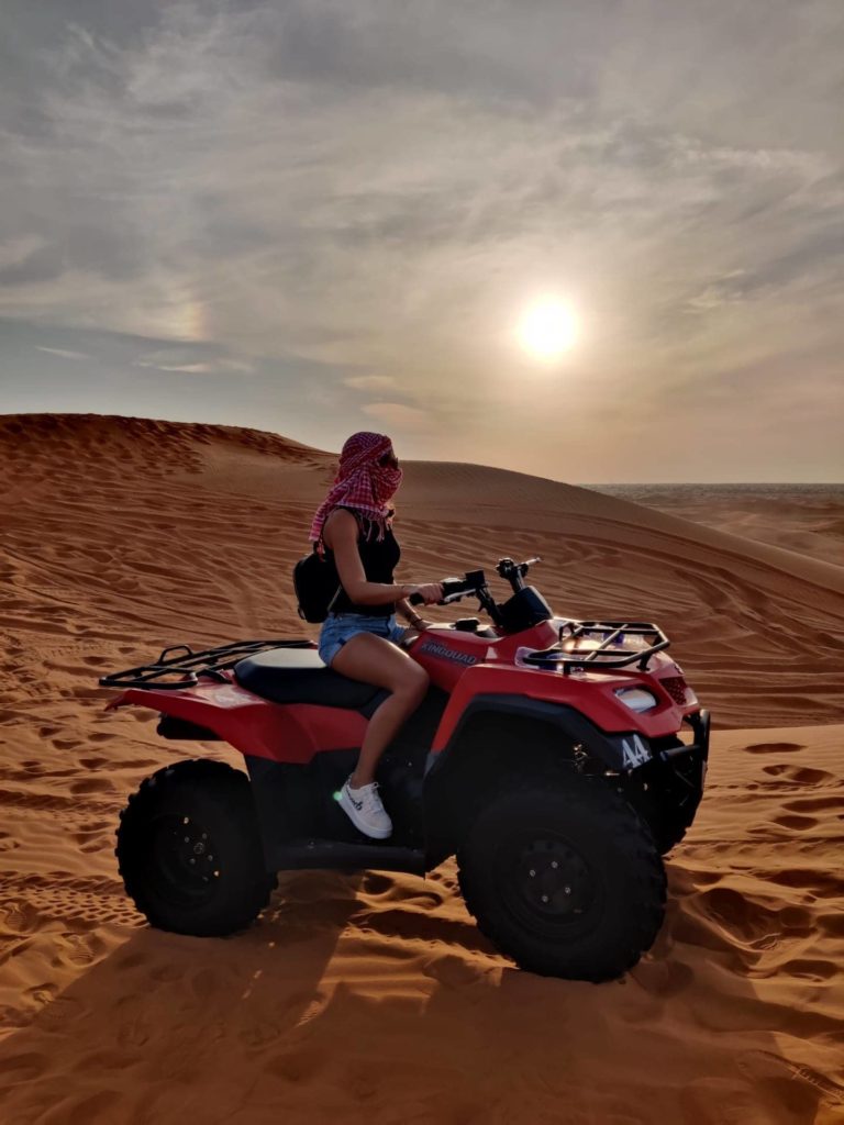 posing on the atv in de desert of dubai