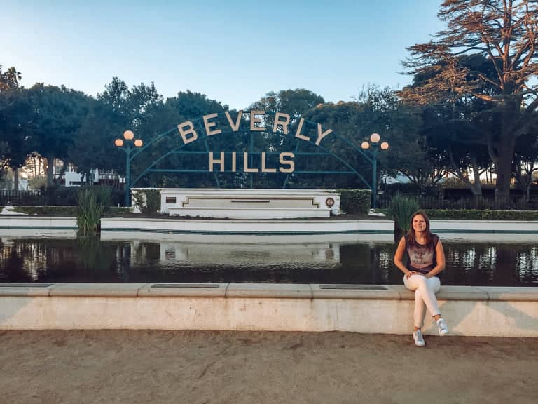 posing in front of beverly hills sign